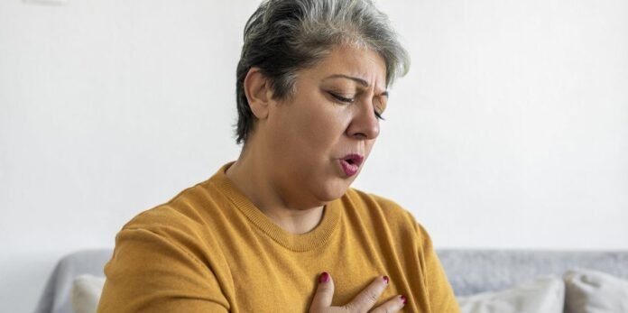 woman-hand-holding-chest-pain-difficulty-to-breathe.jpg